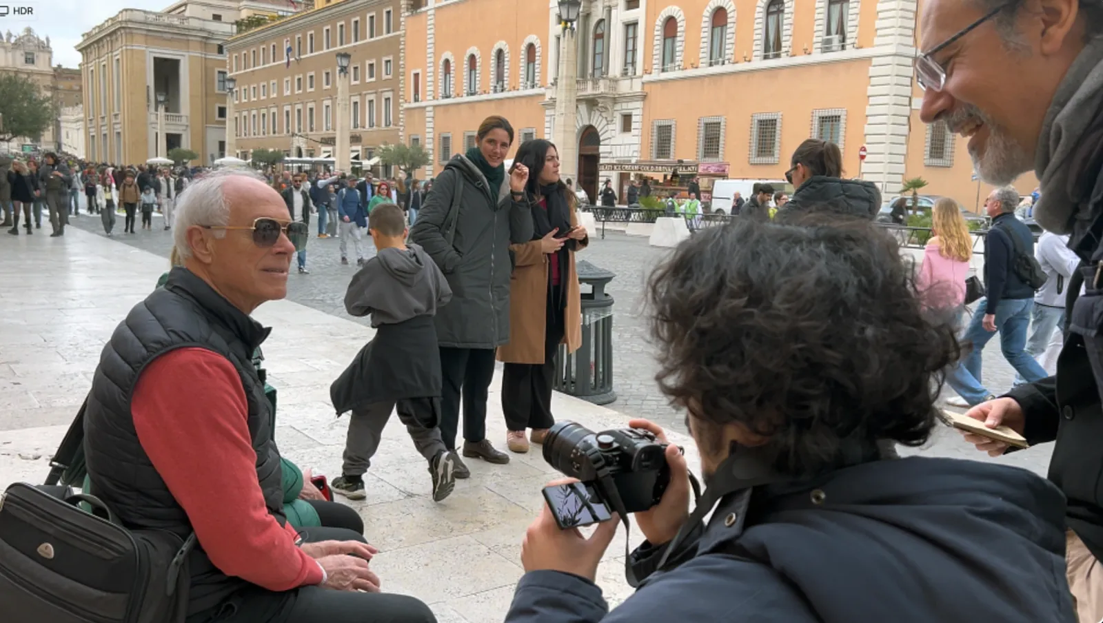 Documentary Gym filming an interview in a public square